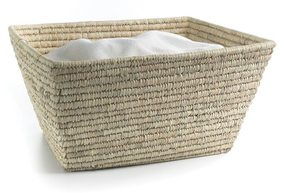 Keep laundry organized in attractive, natural baskets such as the Rectangular Palm Leaf Basket from The Container Store.